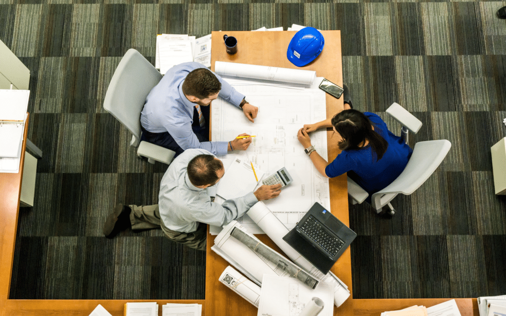 Workers discussing plans at table