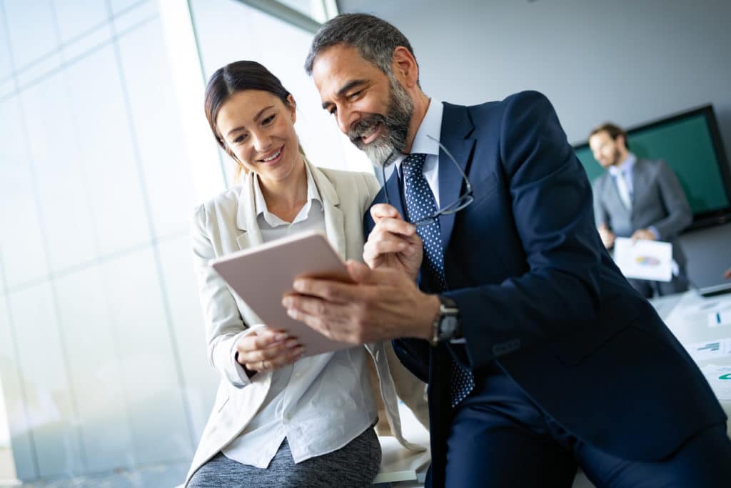 Business colleagues talk about how to form a C-Corporation.
